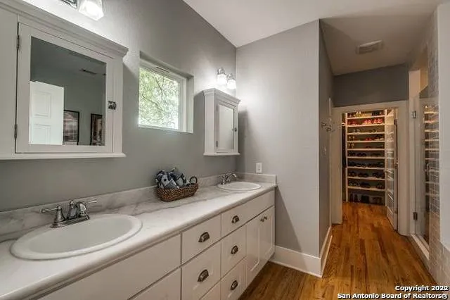 a bathroom with a double vanity sink and mirror