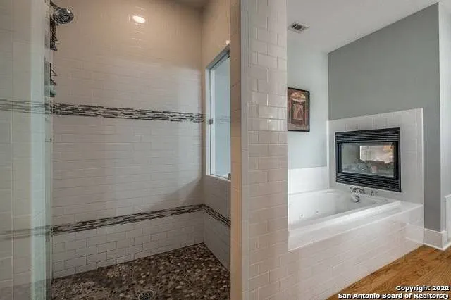 a bathroom with a bathtub and a shower