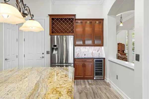 a bedroom with a bed and a dresser with wooden floor