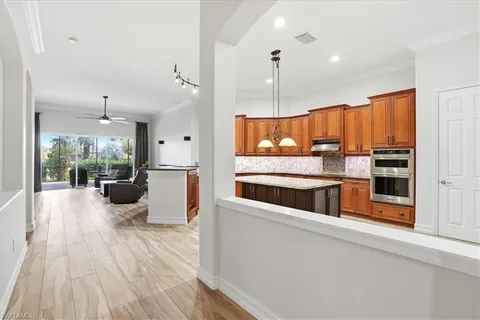 a kitchen with counter top space a sink and stainless steel appliances