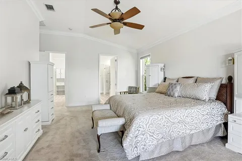 a spacious bedroom with a bed and a chandelier