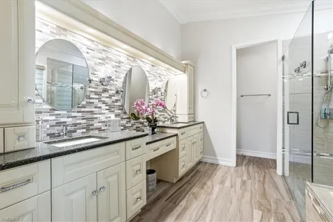 a spacious bathroom with a granite countertop sink mirror and a