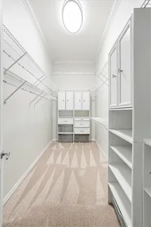 a view of walk in closet with empty racks