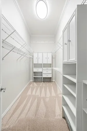 a view of walk in closet with empty racks