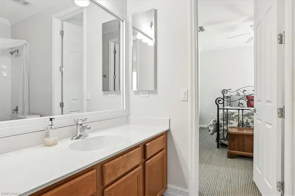 a en suite bathroom with a sink a mirror and a shower