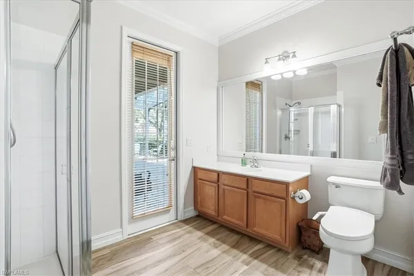 a bathroom with a double vanity sink toilet and shower