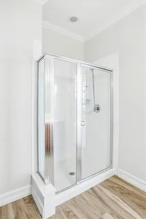 a bathroom with a glass shower door