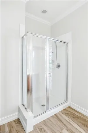 a bathroom with a glass shower door