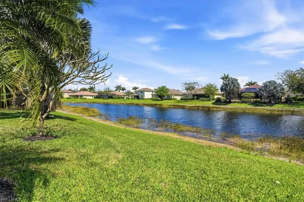 a view of a lake with houses in the back