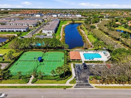 an aerial view of a house with a yard and lake view