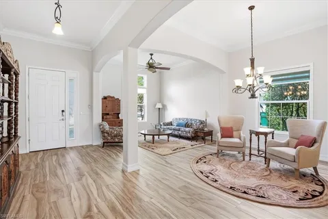 a living room with furniture and a chandelier
