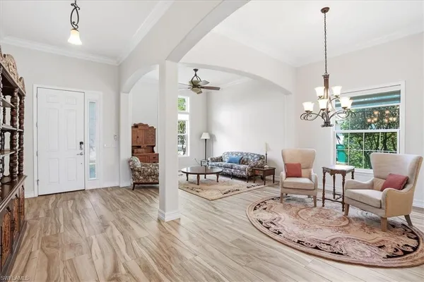 a living room with furniture and a chandelier