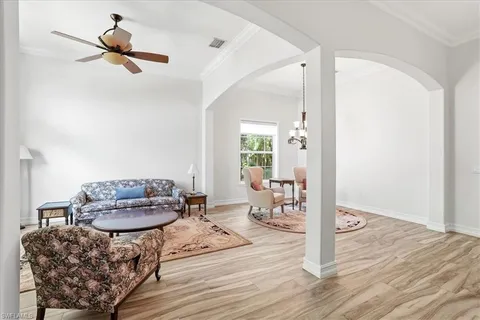 a living room with furniture and a chandelier