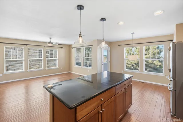 a kitchen with stainless steel appliances granite countertop a refrigerator a stove a sink and a granite counter tops