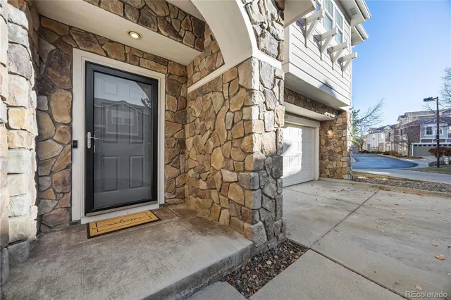 a view of a door of a brick house with a street