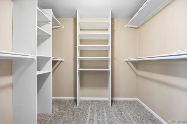 a bathroom with a granite countertop sink a toilet and a large mirror