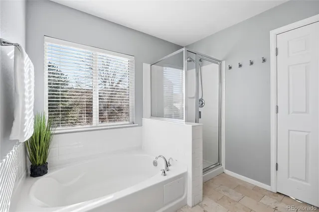 a spacious bathroom with a granite countertop sink a mirror and a shower
