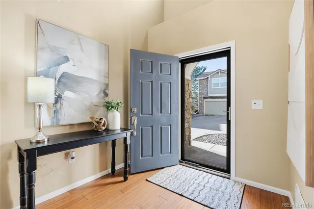 a view of a hallway with wooden floor and entryway