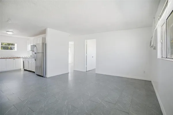 a view of a kitchen with a refrigerator a microwave and a sink