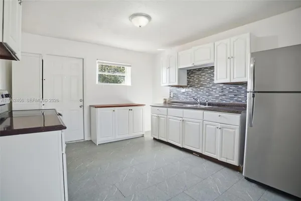 a kitchen with cabinets and white stainless steel appliances