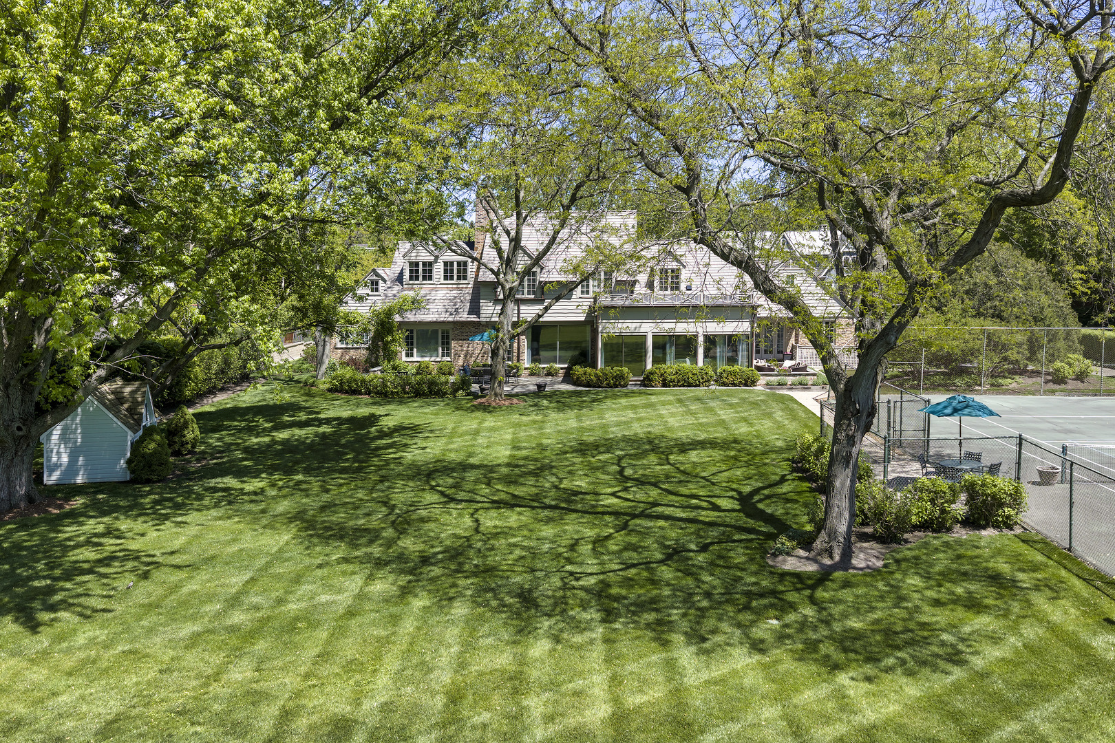936 Sunset Road Winnetka, IL 60093 - Photo 46 of 50 a front view of a house with a garden