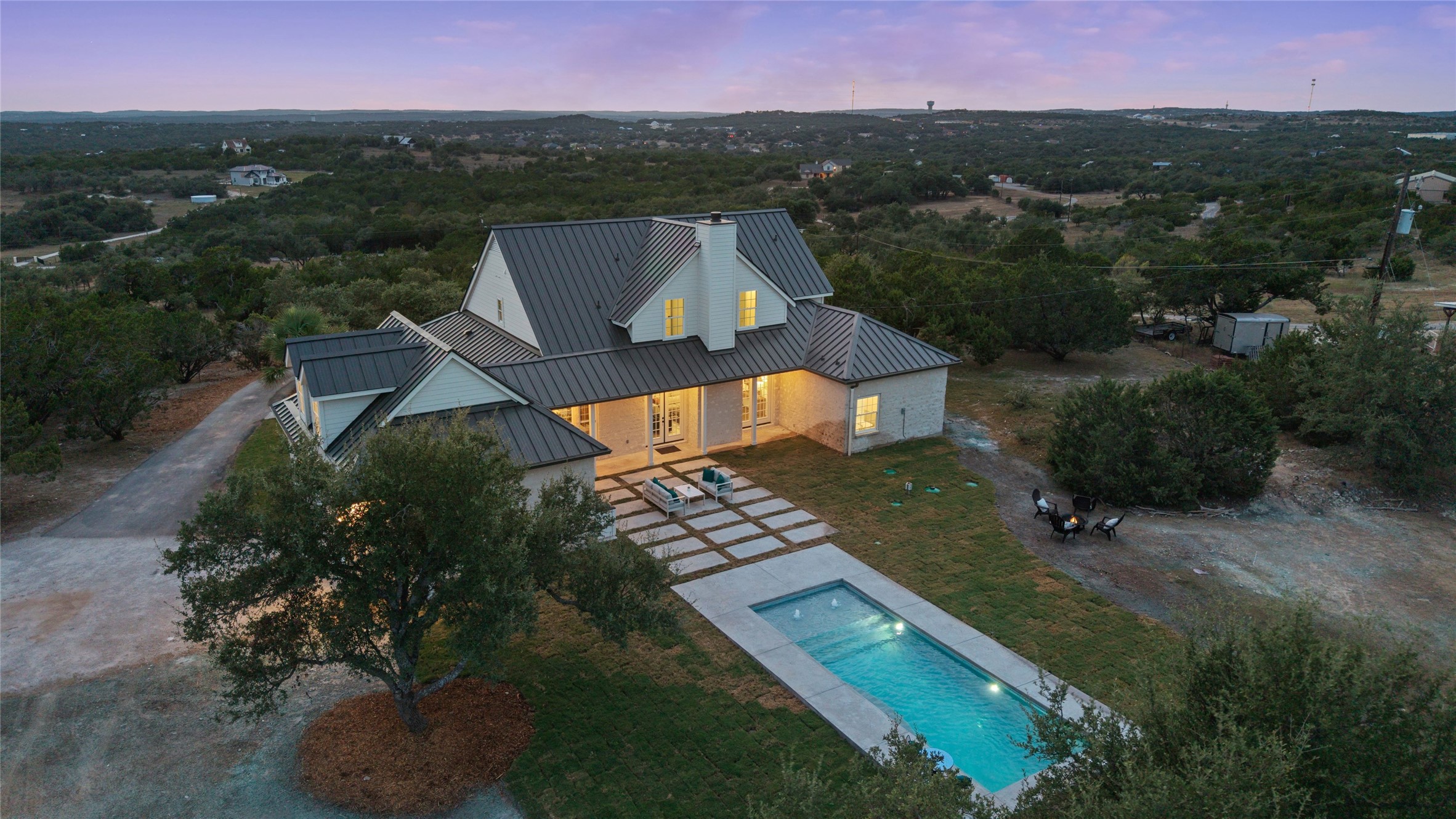 601 Hays Country Acres Road Dripping Springs, TX 78620 - Photo 1 of 38 An inviting swimming pool and paved patio highlight this beautiful home nestled in scenic hills.