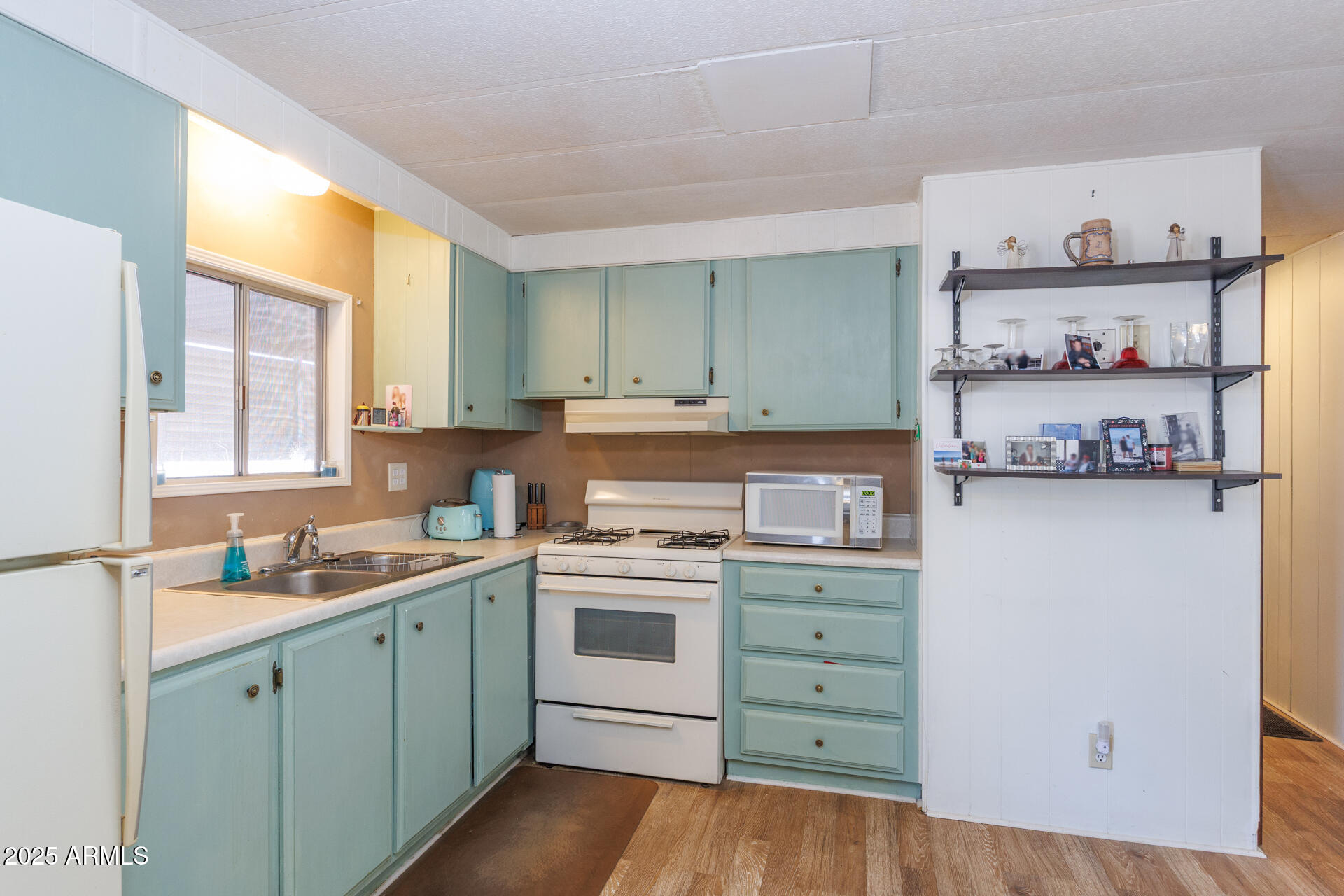 2100 North Trekell Road, Unit 333 Casa Grande, AZ 85122 - Photo 11 of 39 a kitchen with cabinets wooden floor and a window