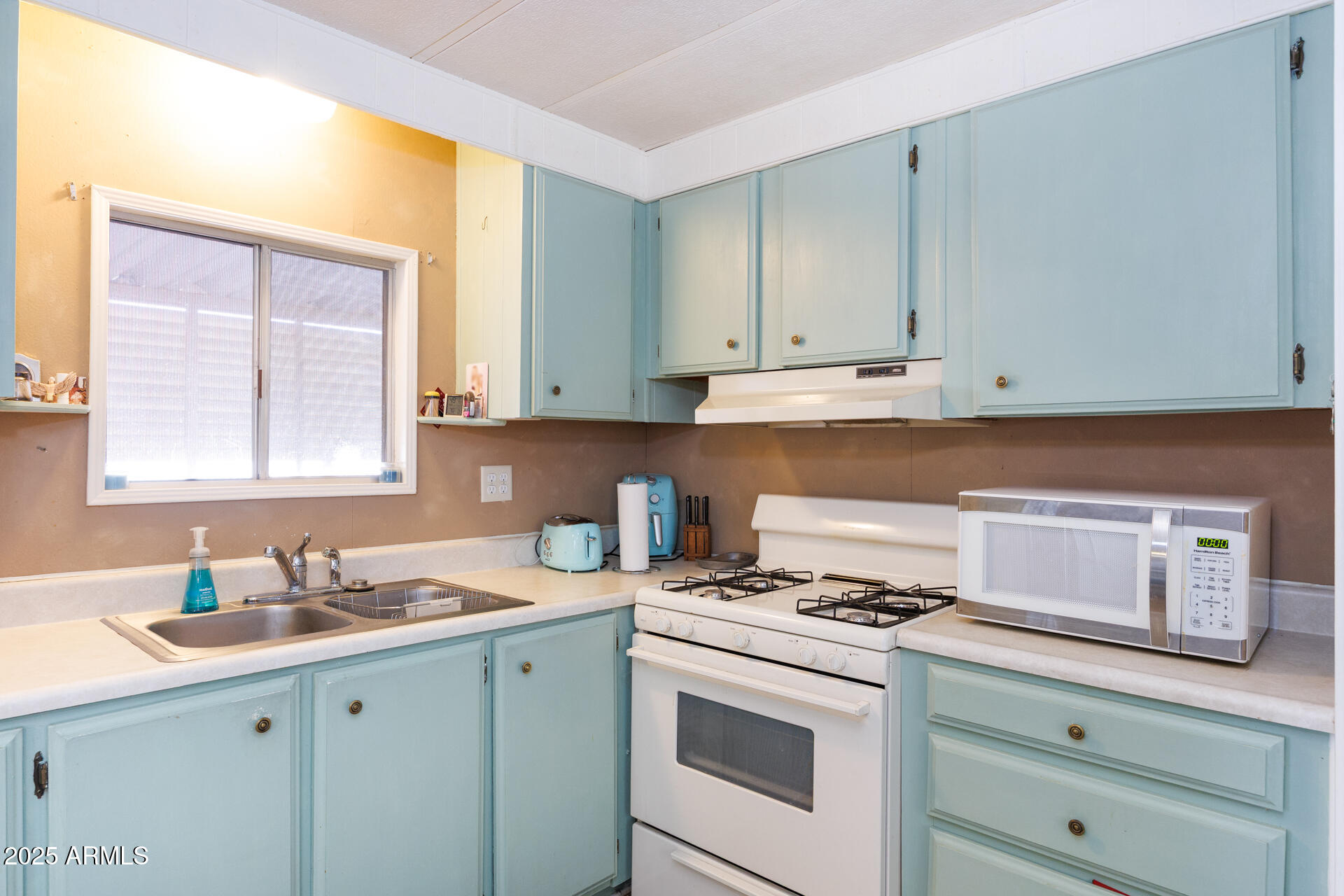 2100 North Trekell Road, Unit 333 Casa Grande, AZ 85122 - Photo 12 of 39 a kitchen with a sink stove and cabinets