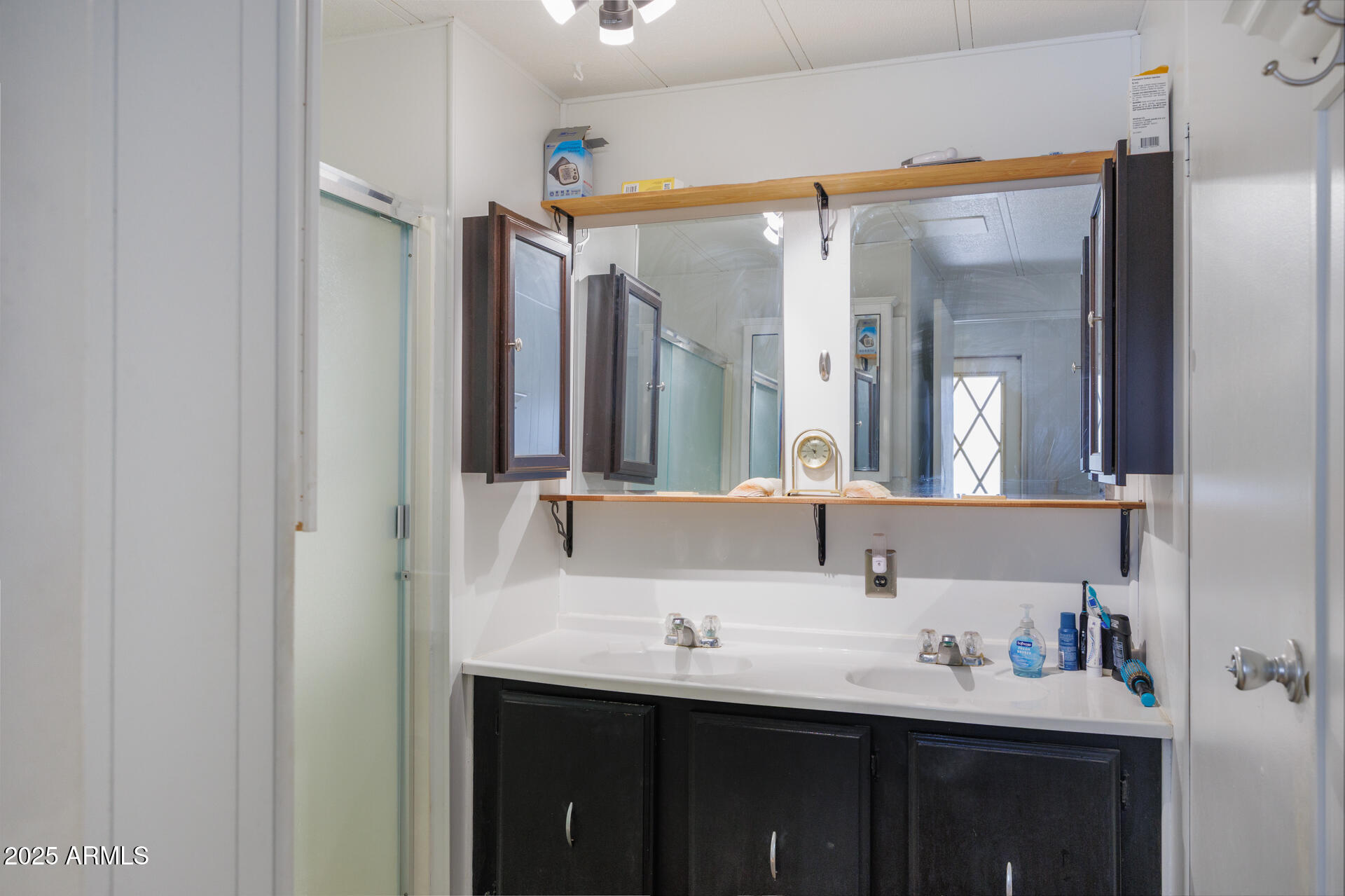 2100 North Trekell Road, Unit 333 Casa Grande, AZ 85122 - Photo 18 of 39 a bathroom with a double vanity sink and mirror