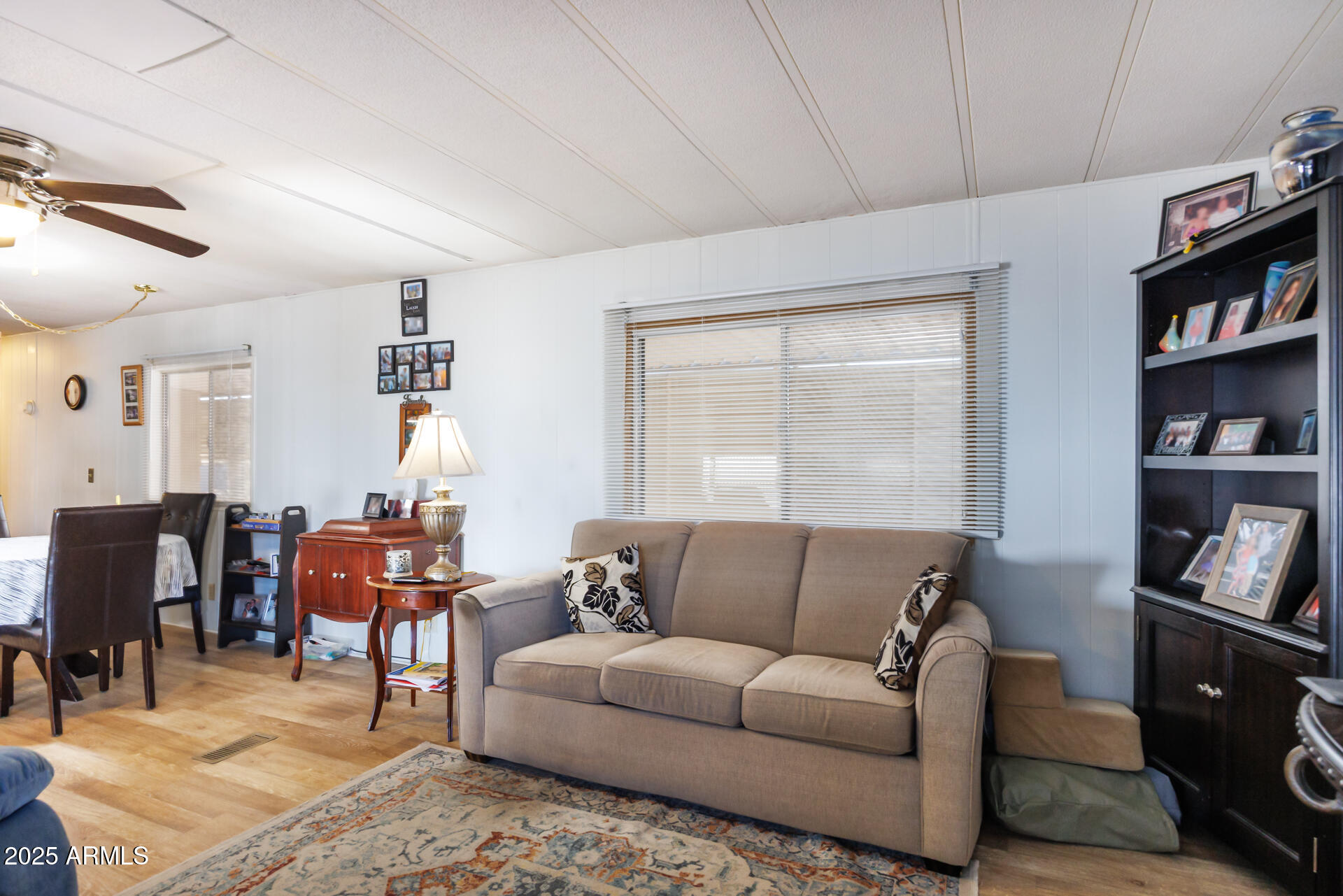 2100 North Trekell Road, Unit 333 Casa Grande, AZ 85122 - Photo 9 of 39 a living room with furniture a bookshelf and a window
