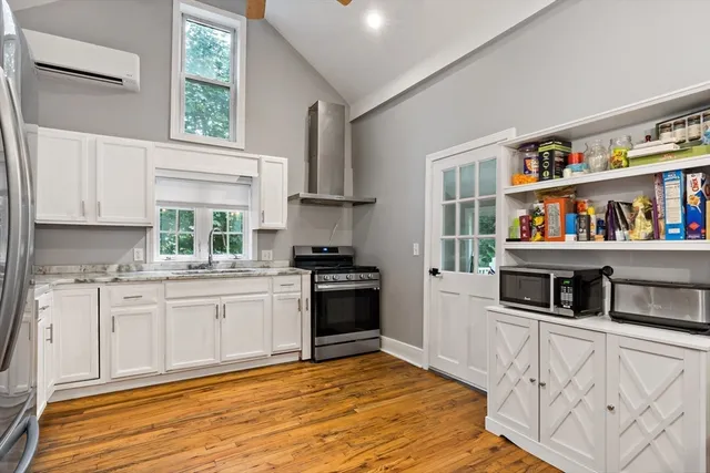 a kitchen with stainless steel appliances granite countertop a stove a sink and a refrigerator