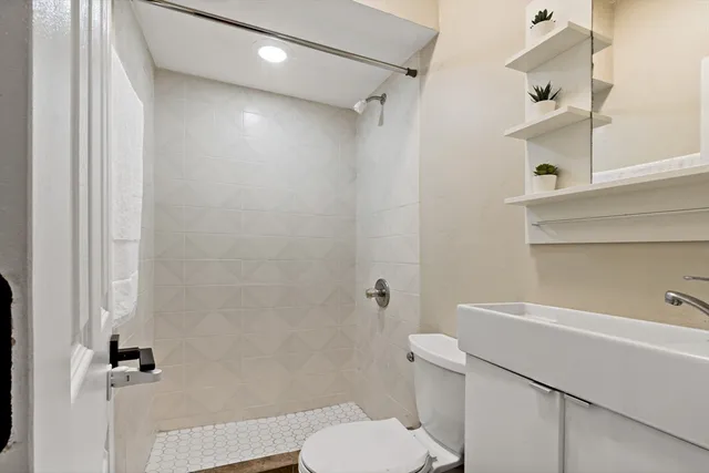 a bathroom with a toilet and a shower