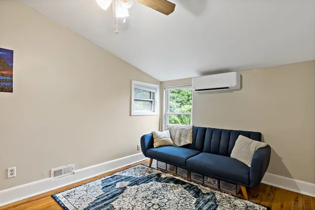 a living room with a couch and a potted plant