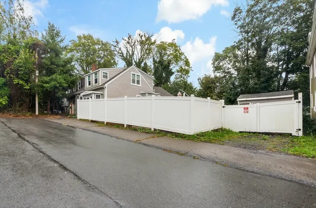 a white house that has a tree in front of it