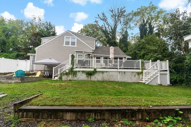 a view of a house with a big yard and potted plants