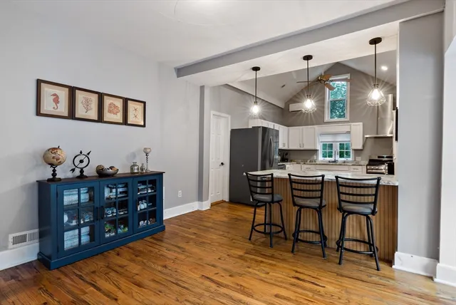 a view of a dining room with furniture and wooden floor