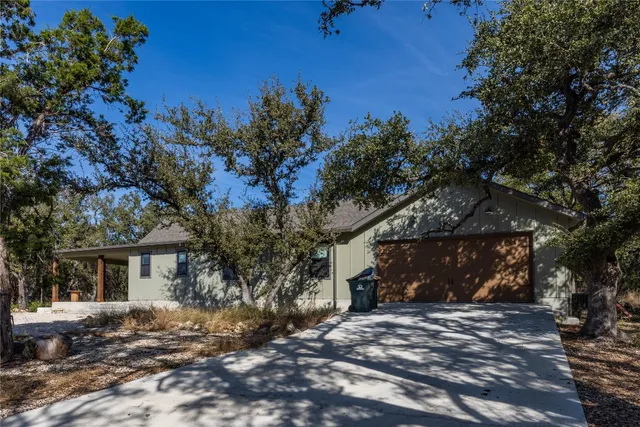 a view of a house with a tree in the background