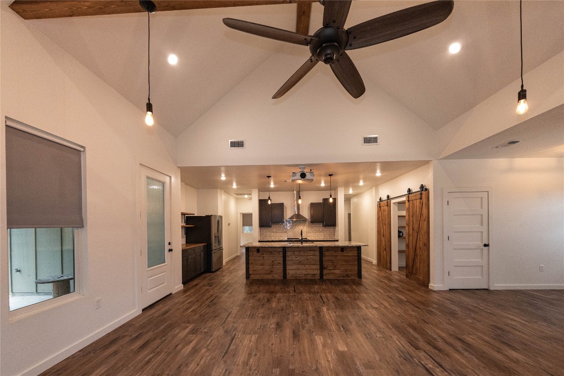 201 Frontier Trail Wimberley, TX 78676 - Photo 15 of 37 a view of a room with wooden floor and a ceiling fan