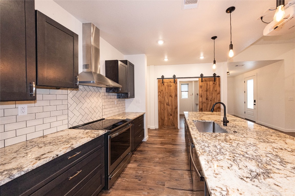 201 Frontier Trail Wimberley, TX 78676 - Photo 18 of 37 a large kitchen with stainless steel appliances kitchen island granite countertop a large counter top and wooden cabinets