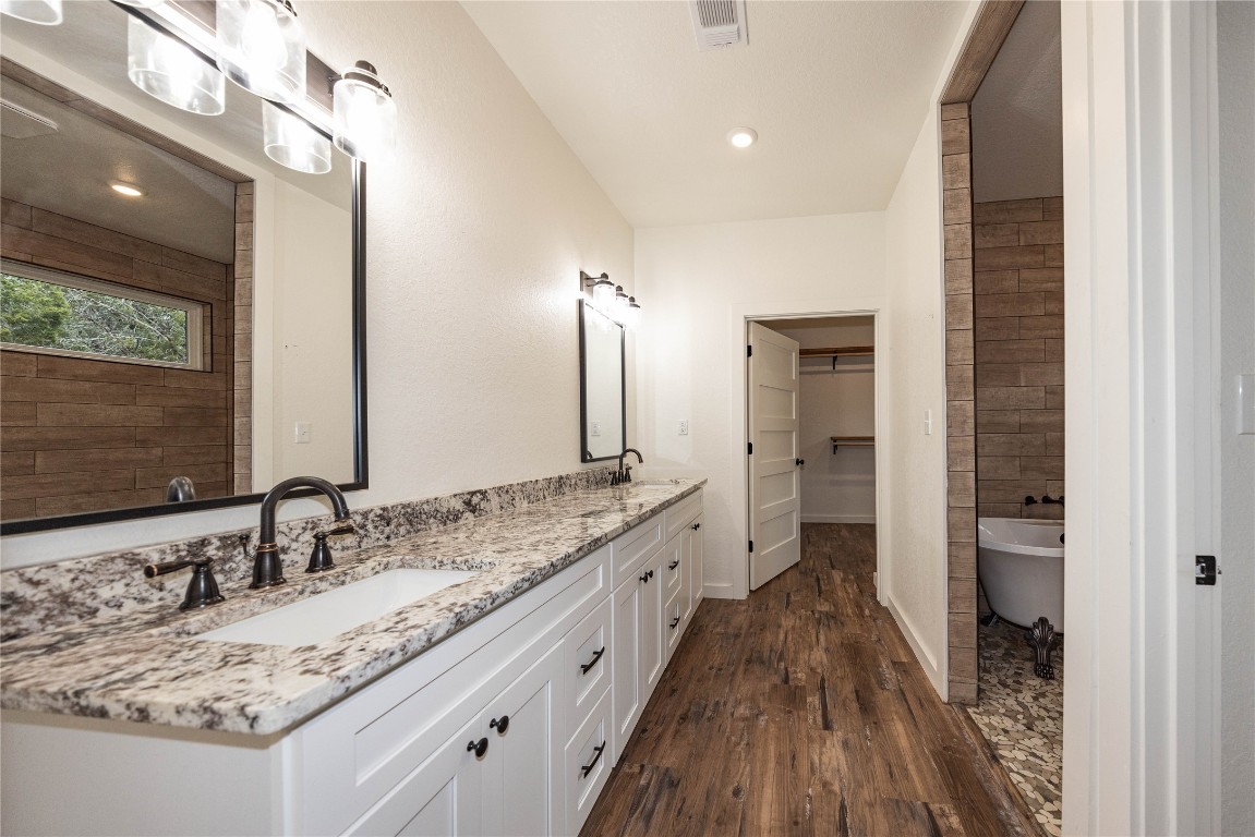 201 Frontier Trail Wimberley, TX 78676 - Photo 24 of 37 a bathroom with a granite countertop double vanity sink and a mirror