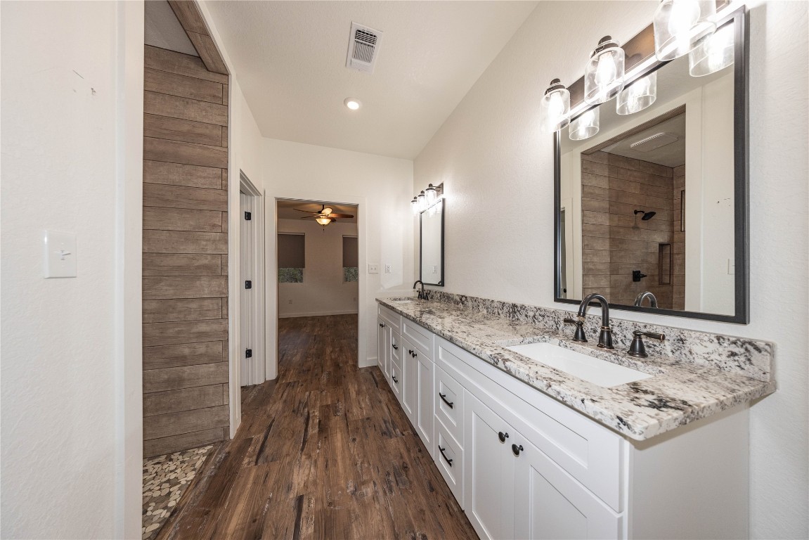 201 Frontier Trail Wimberley, TX 78676 - Photo 26 of 37 a bathroom with a granite countertop double vanity sink and a mirror