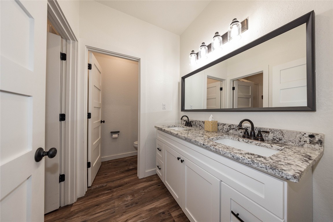 201 Frontier Trail Wimberley, TX 78676 - Photo 30 of 37 a bathroom with a granite countertop double vanity sink and mirror