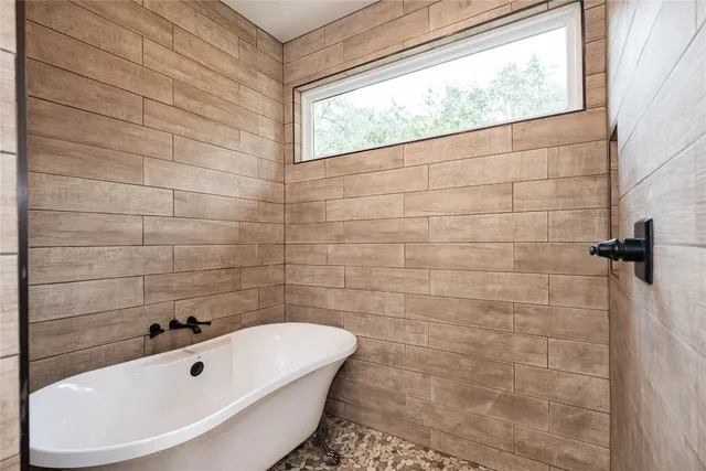 a white bath tub sitting next to a white sink