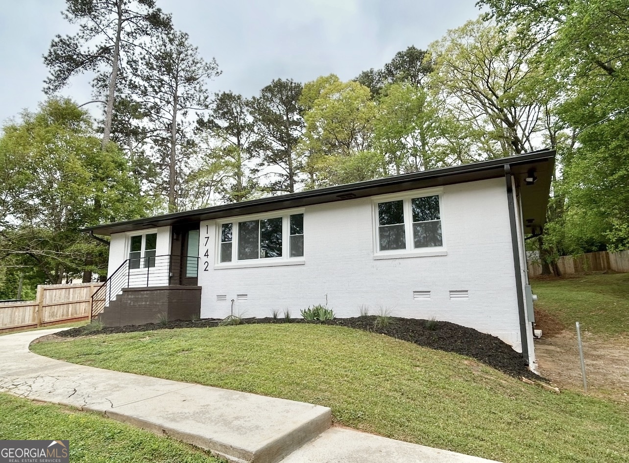 1742 Constitution Road Southeast Atlanta, GA 30316 - Photo 3 of 32 a view of a white house with a yard