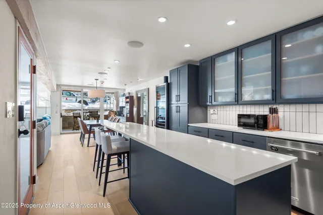 a large kitchen with lots of counter space and stainless steel appliances