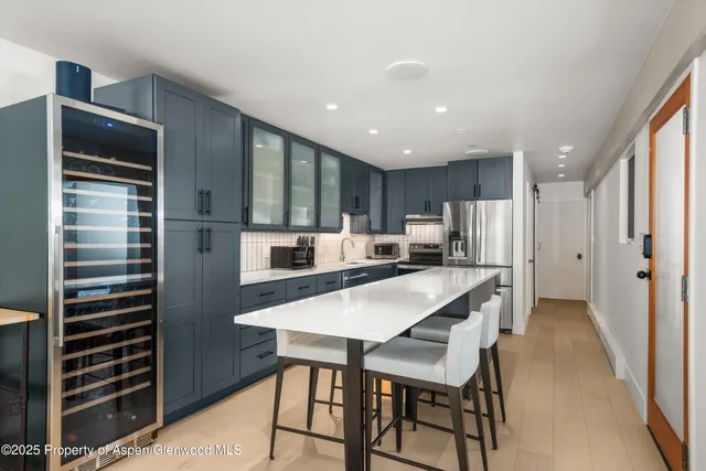 a kitchen with refrigerator and cabinets