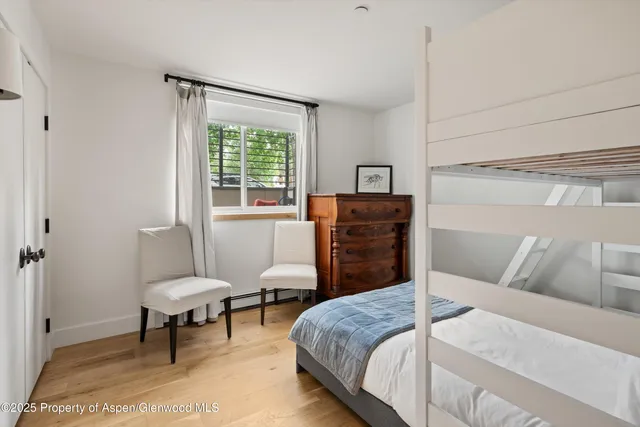 a bedroom with a bed and a chair