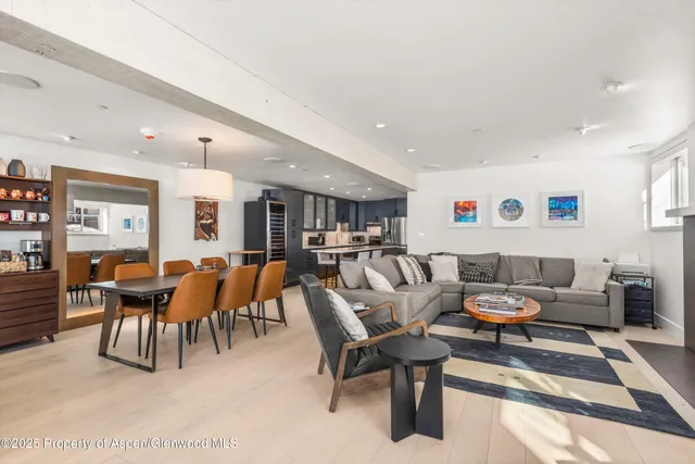 a living room with furniture a table and chairs in it