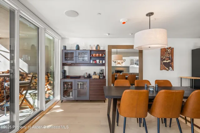 a dining room with furniture and a chandelier