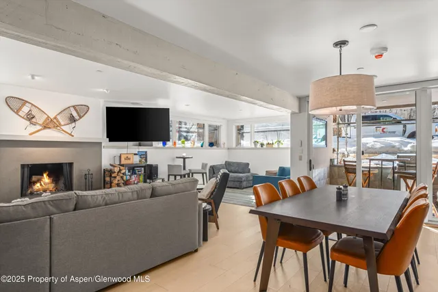 a living room with furniture a flat screen tv and kitchen view